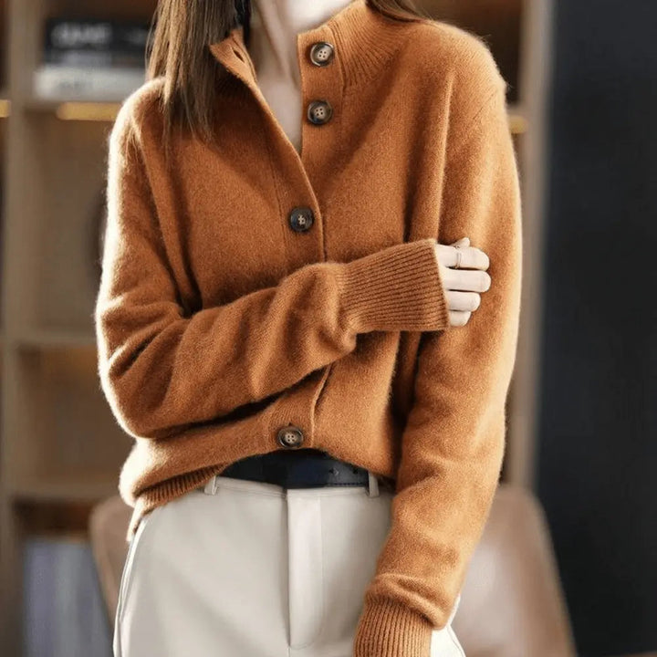 Margot stand collar cardigan in rust, close-up with folded arms