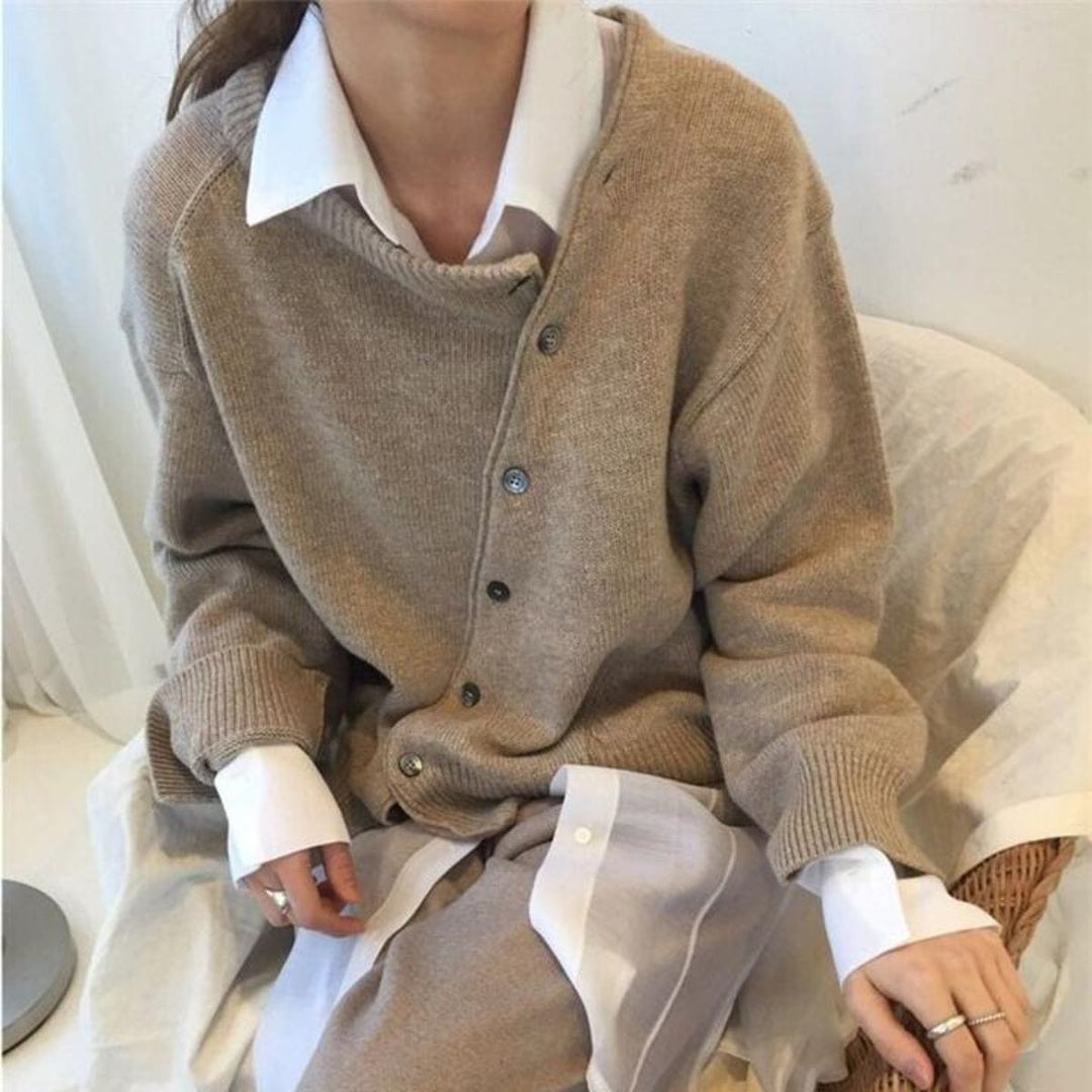 Nora asymmetric button cardigan in taupe layered over a white collared shirt, front detail close-up