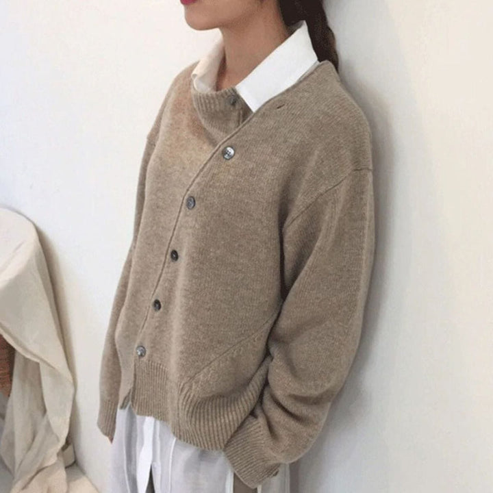 Nora asymmetric button cardigan in taupe, side view layered over a white shirt