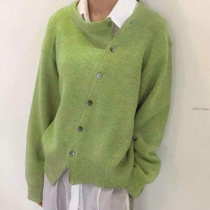 Nora asymmetric button cardigan in green, front view layered over a white collared shirt